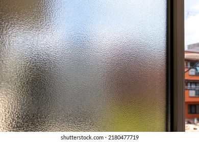 A Slightly Open Frosted Glass Window