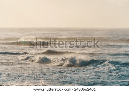 A slightly outoffocus image of waves breaking on a sandy shore