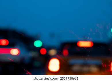 A slightly unclear photograph shows various cars navigating their way along a highway during the nighttime hours, illuminated by streetlights - Powered by Shutterstock