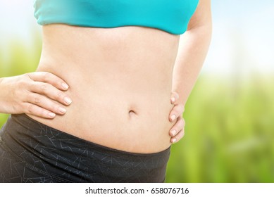 Slim Belly Of Young Athletic Woman With Hands On Waist