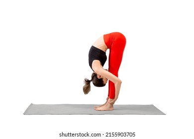 Slim caucasian woman practicing yoga, standing forward fold pose, Uttanasana, isolated on white. Stretching, flexibility, female fitness, workout, training, sport concept.