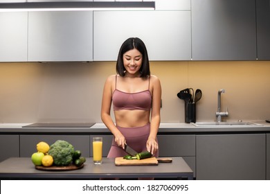 Slim Chinese Lady Cooking Healthy Vegetable Salad In Modern Kitchen, Preparing Dinner For Weight Loss Dieting At Home. Detox Recipes, Nutrition And Diet For Slimming Concept