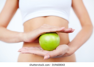 Slim Female Holding Green Apple Between Her Palms