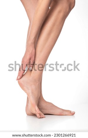 Slim female legs on isolated white background.