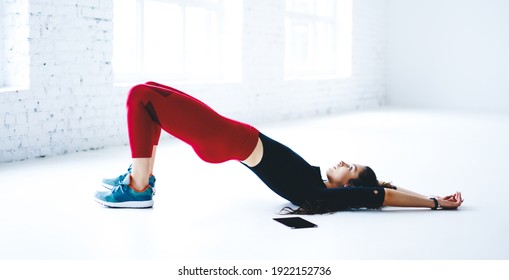 Slim fit girl recreating in sport gym exercising during cardio training for slimming, Caucasian female bodybuilder dressed in stylish tracksuit warming up maintain body positive as lifestyle