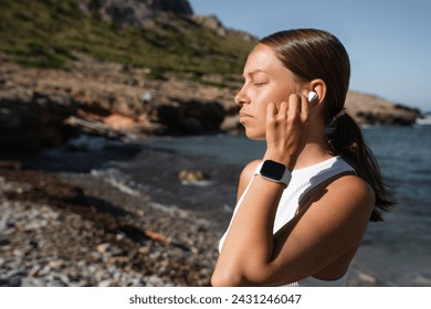 Slim fit woman running jogging doing physical exercises for slimming weight loss, jogging and running. Female athlete listening to the music podcast on the beach shore coast - Powered by Shutterstock