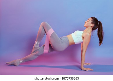 Slim Fitness Woman Stretching Body In Upward Plank Pose, Doing Reverse Planking Exercise With Resistance Elastic Band Indoor, Female Strength Training Her Core With Bodyweight, Flexibility Exercises.