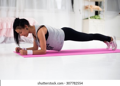 Slim Fitness Young Woman Athlete Girl Doing Plank Exercise At Home Concept Training Workout Crossfit Gymnastics Cross Fit.