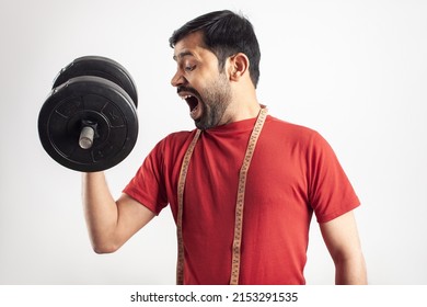 Slim Indian Man Doing Bicep Curl With A Dumbbell In White Background