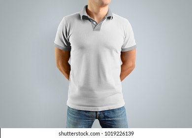 Slim Man In The White Polo Shirt And Blue Jeans  Isolated On The Gray Background, Front View. Mockup For Your Graphic Design.