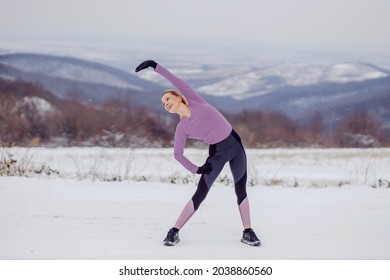 Slim Sportswoman In Shape Doing Warmup And Stretching Exercises In Nature At Snowy Winter Day. Healthy Habits, Winter Fitness