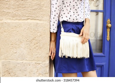 Slim Tanned Girl In Clothes In A Marine Style. Marine Style Of Dress. White Bag With Fringe. Indigo Blue. Saturated Blue. Street Fashion. Fashion Model. Fashion Street Look. Items Of Clothing.