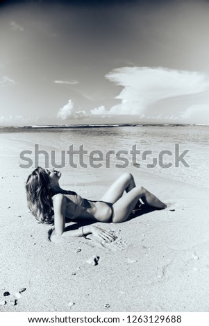 Slim woman enjoying on a sandy tropical beach.
