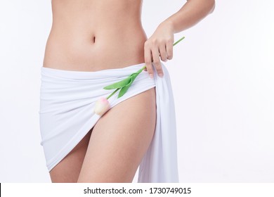 Slim Woman , Holding A White Flower In Her Hands, Close-up. Gynaecology, Menstruation, The Concept Of Genital Health