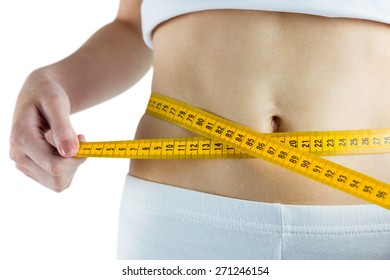Slim woman measuring her waist on white background