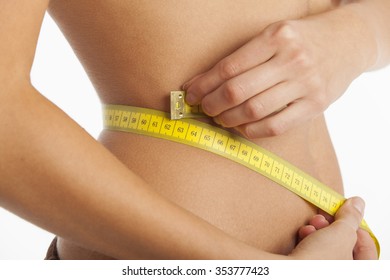 slim woman with a measuring tape 