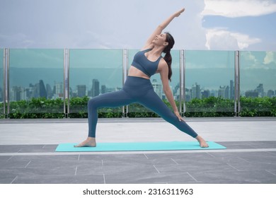 Slim woman practicing yoga on the balcony of her condo. Asian woman doing exercises in morning. balance, meditation, relaxation, calm, good health, happy, relax, healthy lifestyle concept
 - Powered by Shutterstock