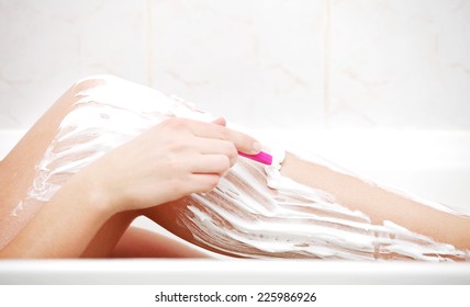 Slim Woman Shaving Her Leg