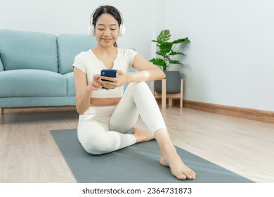 Slim woman use phone and feel recreation on yoga activity. Asian woman exercises in morning. balance, meditation, relaxation, calm, good health, happy, relax, healthy lifestyle, diet, slim - Shutterstock ID 2364731873