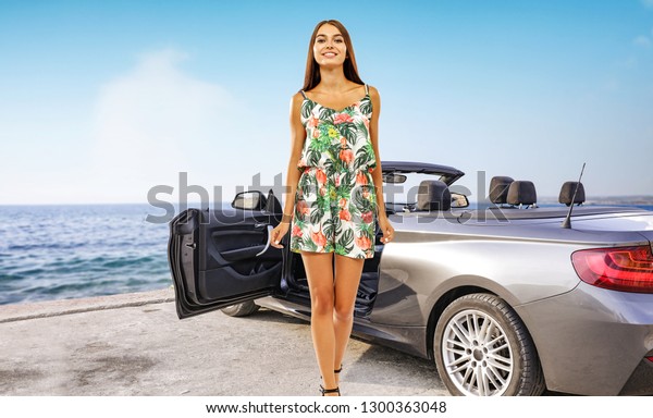 Slim\
young rich woman and summer silver car on coast. Sea landscape and\
sky of blue color. Free space for your decoration.\
