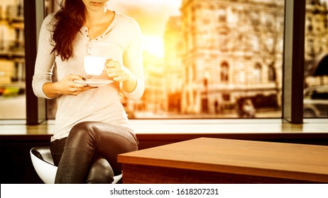 Slim Young Woman In Cafe Interior Lookin On Street In Paris.Wooden Corner Of Table And Free Space For Your Decoration.Sunset Time And Copy Space. 