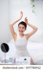 Slim young woman shows tender smooth armpit skin in bedroom