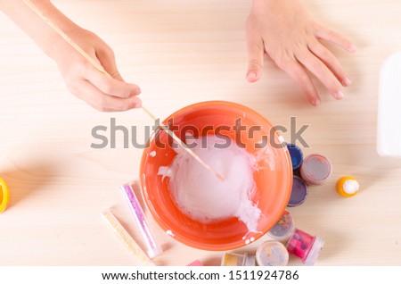 Slime making process. Kid making slime, worldwide popular self made toy.