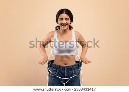 Slimming Concept. Happy Slim Indian Woman Wearing Oversized Jeans Posing On Beige Background, Smiling Female With Drawn Fat Silhouette Around Body Comparing Size After Effective Weight Loss, Collage
