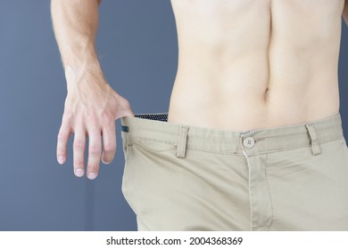 Slimming Muscular Man In Pants That Too Big Closeup