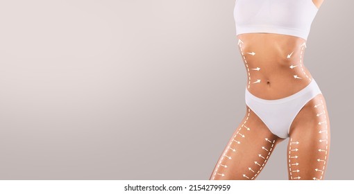 Slimming And Tightening Concept. Closeup cropped of young female model in white top and panties posing with massage lines and arrows on her full body, isolated on studio background, panorama mockup