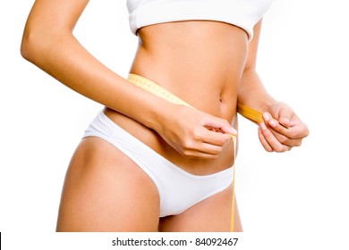 Slimming woman body in panties with measure on white background
