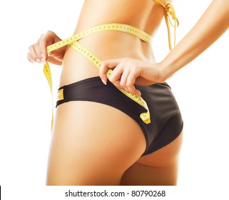 slimming woman in panties with measure on white background