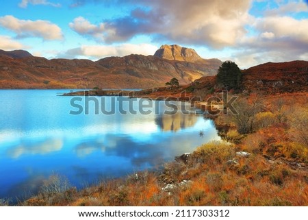 Slioch towering over Loch Maree on a Autumn afternoon. Wester Ross, North West Highlands, Scotland, UK.