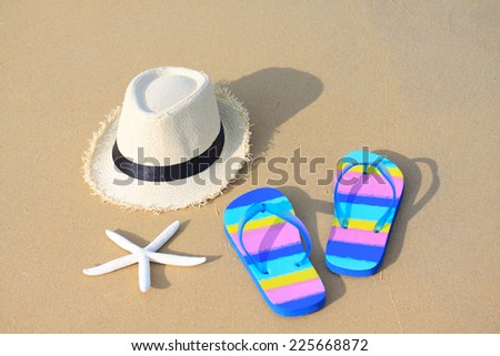 slippers with hat on the beach