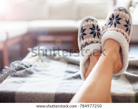 Slippers on women's legs. Soft comfortable home slipper