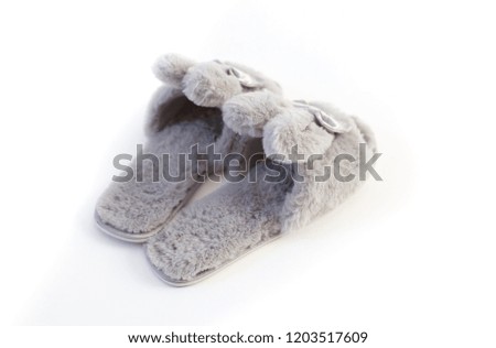 Slippers in the shape of a bunny with ears isolated on a white background, women's or children's indoor clothing, cute fluffy fur slippers home