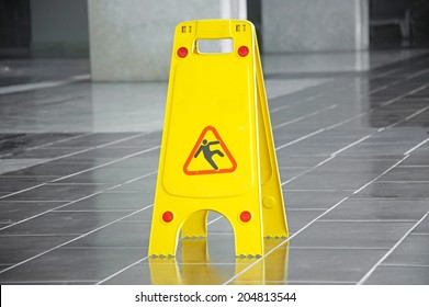 Slippery Floor Surface Warning Sign And Symbol In Building, Hall, Office, Hotel , Restaurant, Restroom. Concept Photo Danger. 