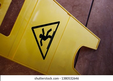 Slippery Floor Yellow Caution Sign On Tiled Floor Top Down View 