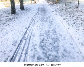 Slippery Ice And Snow On The Sidewalk In Winter