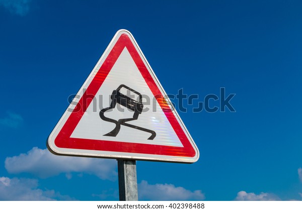 Slippery Road Warning Sign
on blue sky