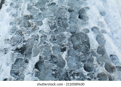 Slippery Sidewalk In Winter Covered With Slush Full Of Footprints