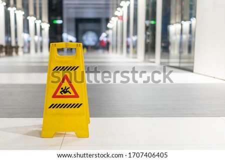 Slippery sign on wet floor in office building