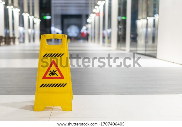 Slippery sign on wet\
floor in office\
building