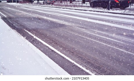 Slippery Snowy City Road During Winter. Difficult Weather Conditions. Dangerous Traffic.