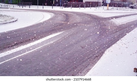 Slippery Snowy City Road During Winter. Difficult Weather Conditions. Dangerous Traffic.