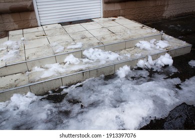 Slippery Stairs Entrance Of Winter Street Store With Ice And Melting Snow 