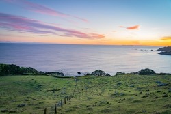 Sloping Stony Field With Long Fence Leading To Edge Of Side Of Mount Maunganui And Distant Horizon, Tauranga New Zealand.