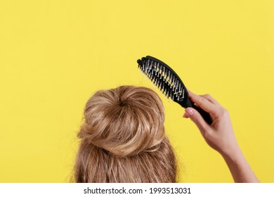 
Sloppy Hairstyle Bun On A Yellow Background.