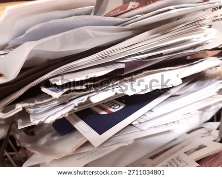 Sloppy stack of papers from bills and ignored junk mail clutter, piled carelessly in an old, overflowing organizer, neglected and messy, in need of a deep clean de-cluttering or office filing system.