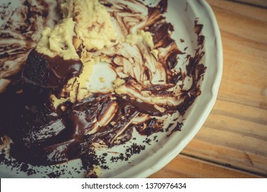 Sloppy Stains Of Dish After Eating Chocolate Cake. Dirty Plate After Dessert